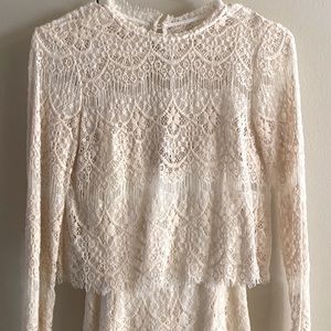Cream lace romper from anthropology. Flattering xs fit. Quality material.
